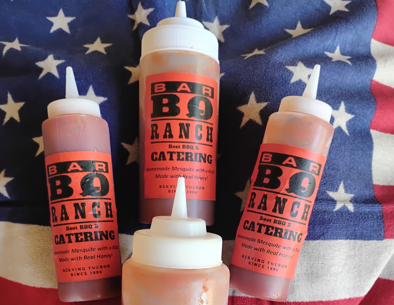 Four bottles of Bar-BQ-Ranch Homemade BBQ sauce